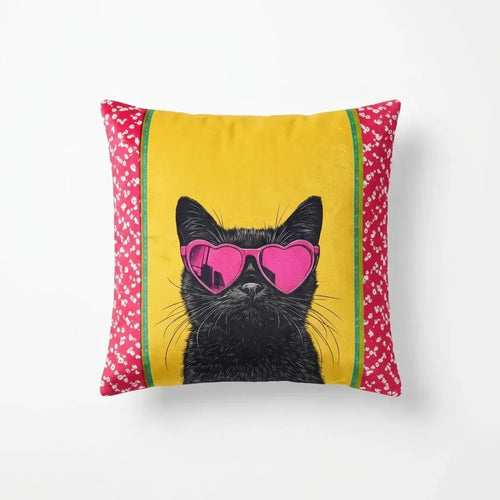 Pillow with a black cat wearing pink sunglasses on a yellow background