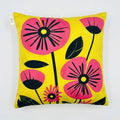 Decorative pillow with pink flowers on a yellow background